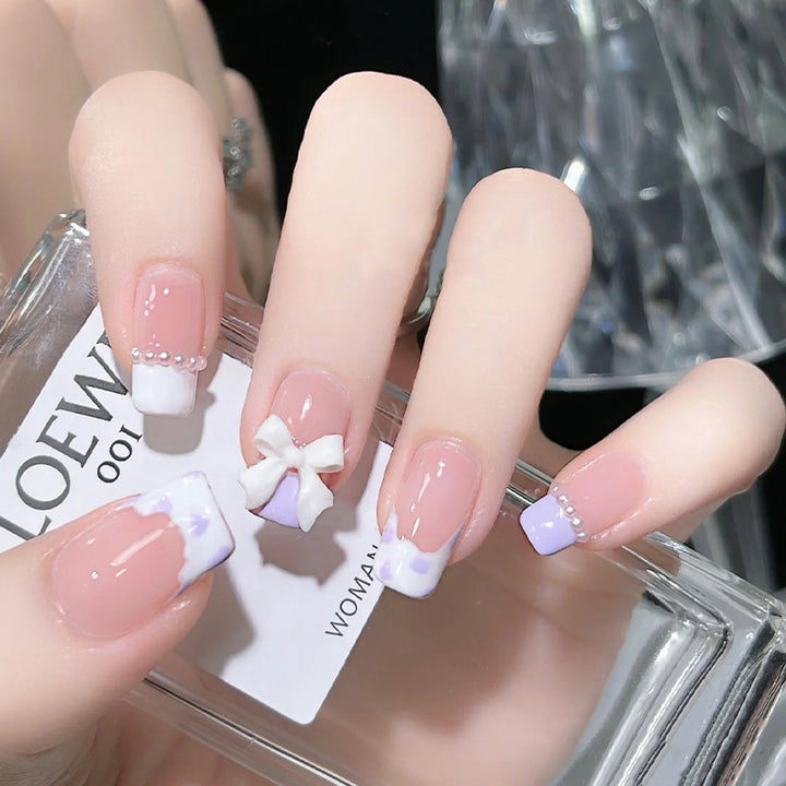 Nail art set with elegant wave patterns and delicate pearl accents Bowlift