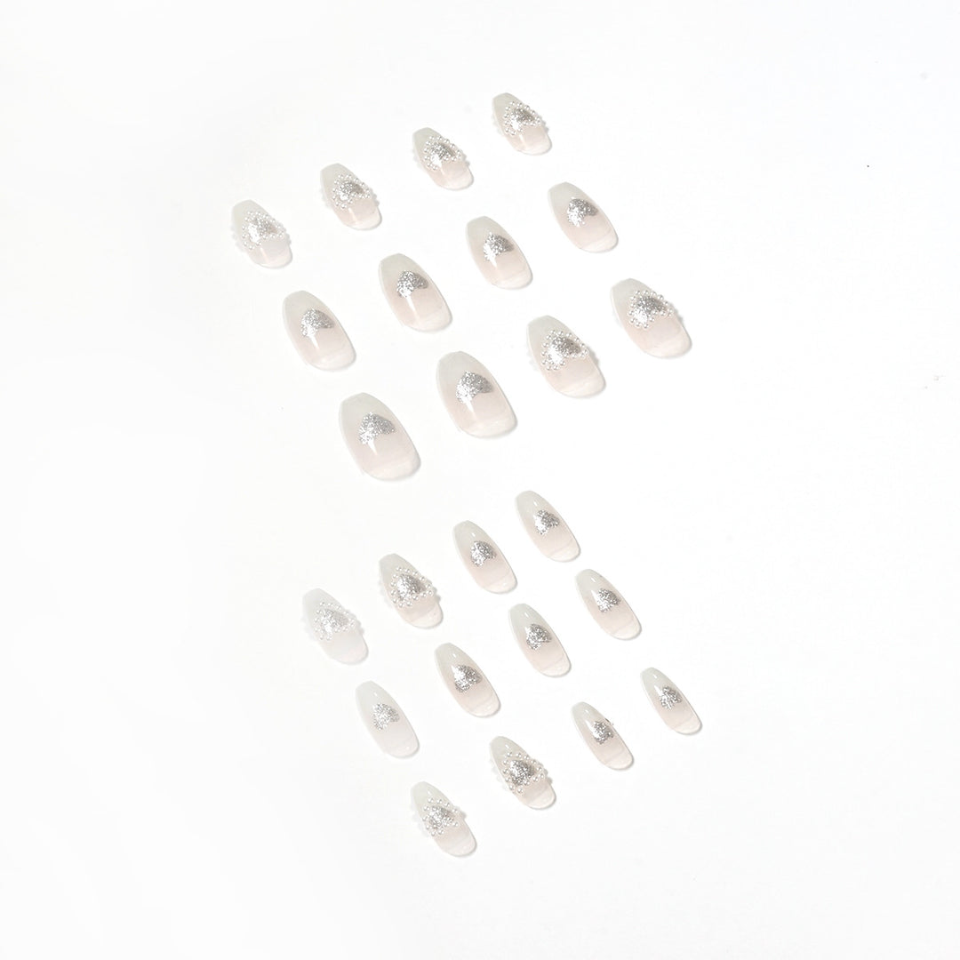 Artificial nail art with heart and rhinestone decorations Bowlift
