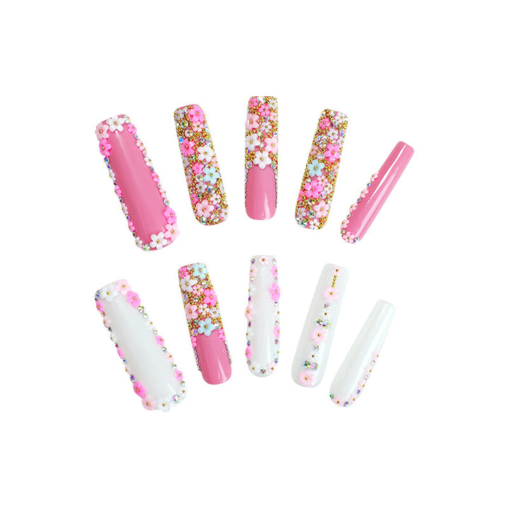 Artificial nail set with floral decorations and glitter accents Bowlift