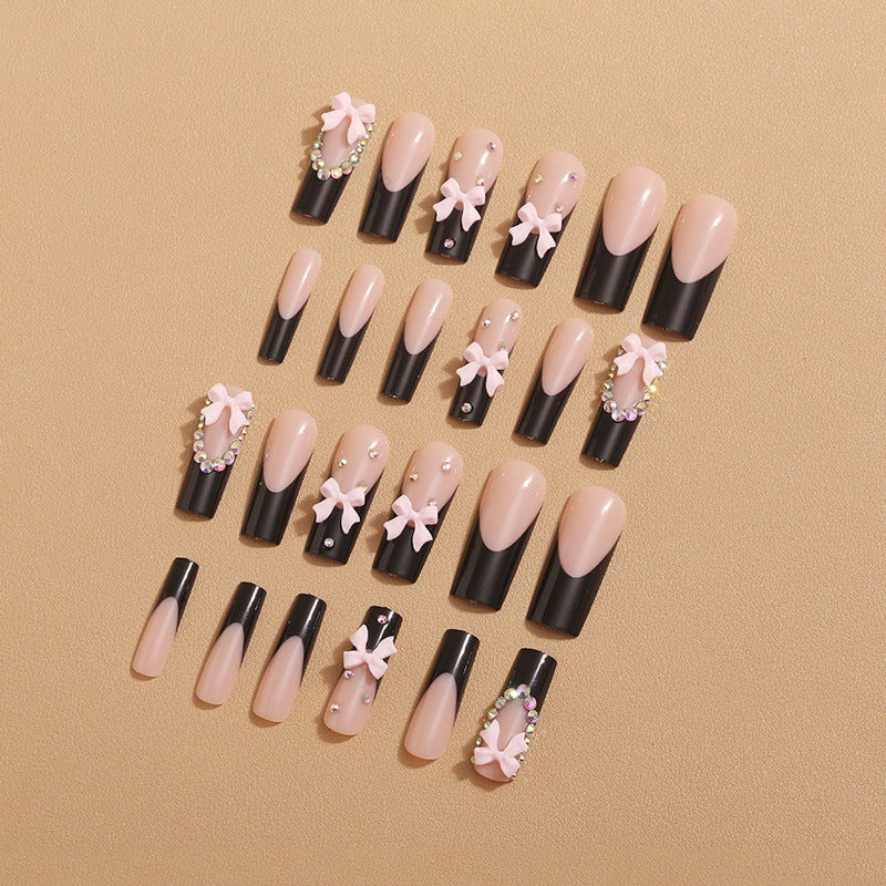 Artificial nails with elegant bows and rhinestone embellishments Bowlift