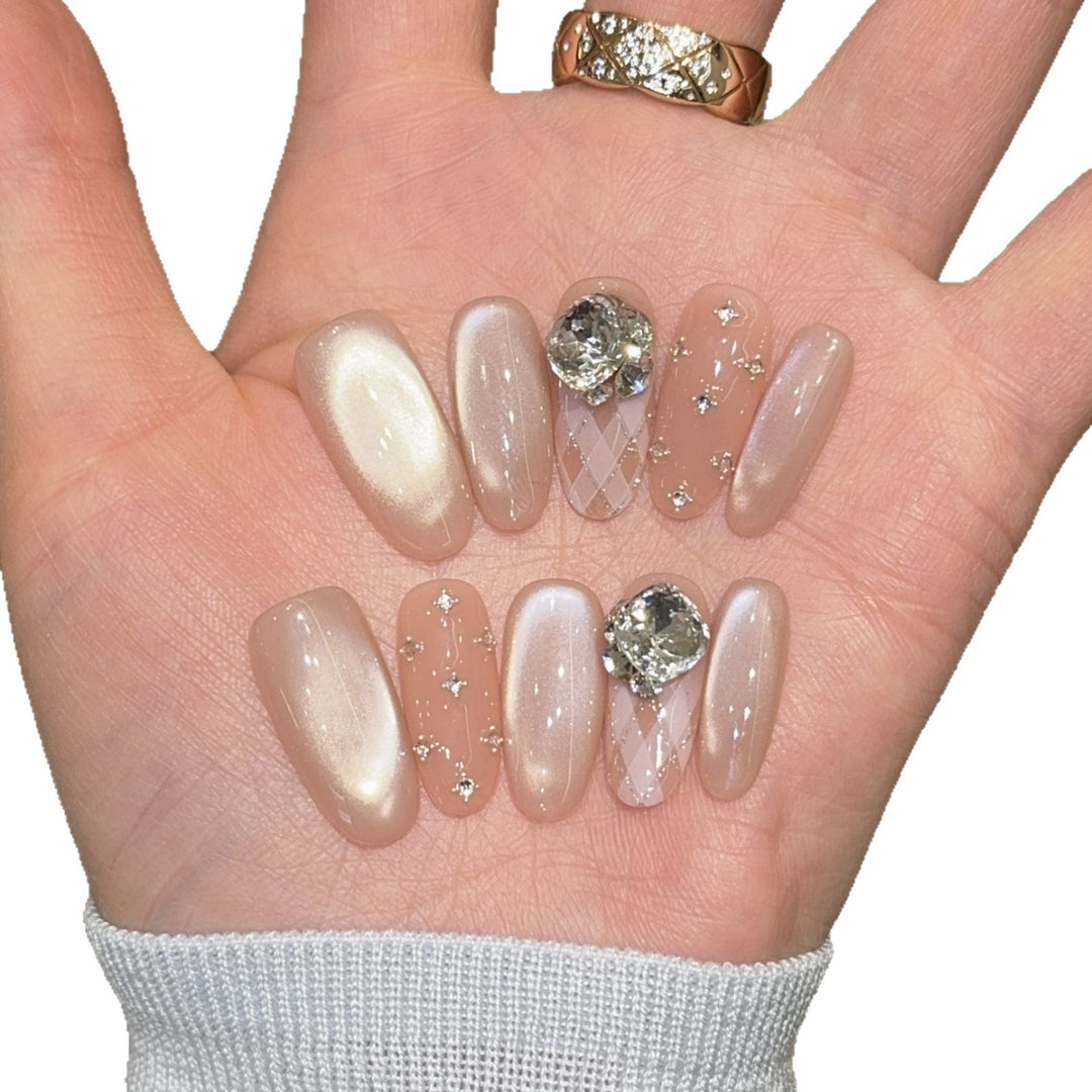 Elegant artificial nails with shimmering effects and rhinestone accents Bowlift