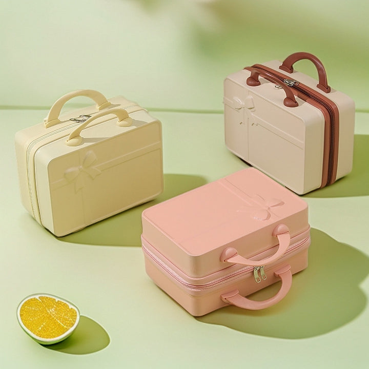 structured hard-shell cosmetic travel case with embossed bow and dual top handles Bowlift