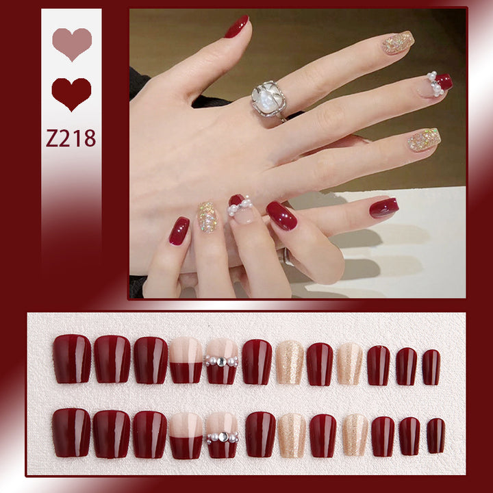Glamorous artificial nails with glitter and pearl decorations Bowlift