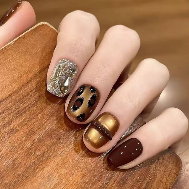 Glamorous artificial nails with animal design and glitter accents Bowlift