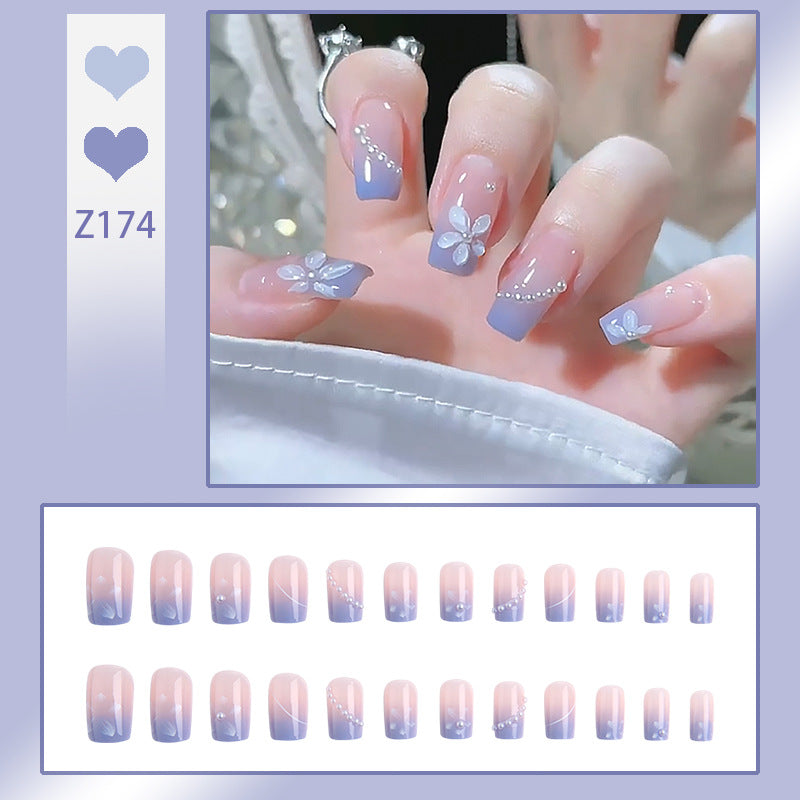 Nail set with elegant floral accents and glitter embellishments Bowlift