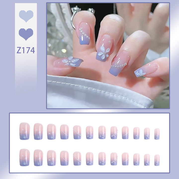 Nail set with elegant floral accents and glitter embellishments Bowlift