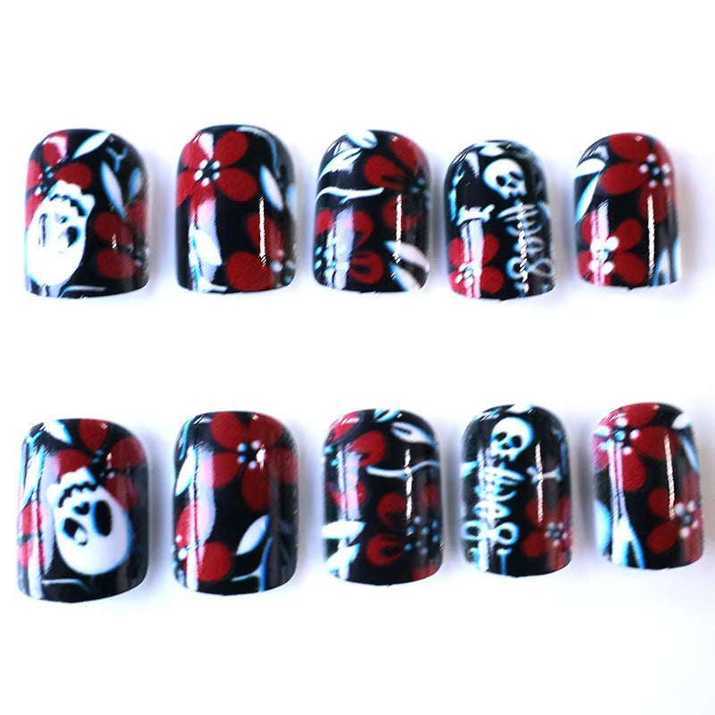 Creative nail art with skull motif and floral elements Bowlift