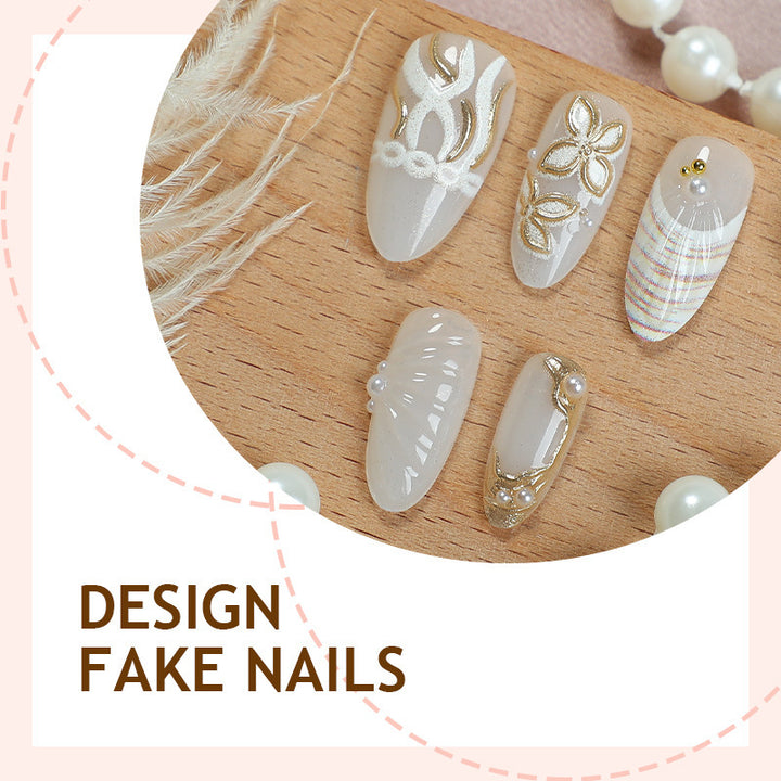 Artificial nail set with luxurious gold embellishments and elegant natural motifs Bowlift