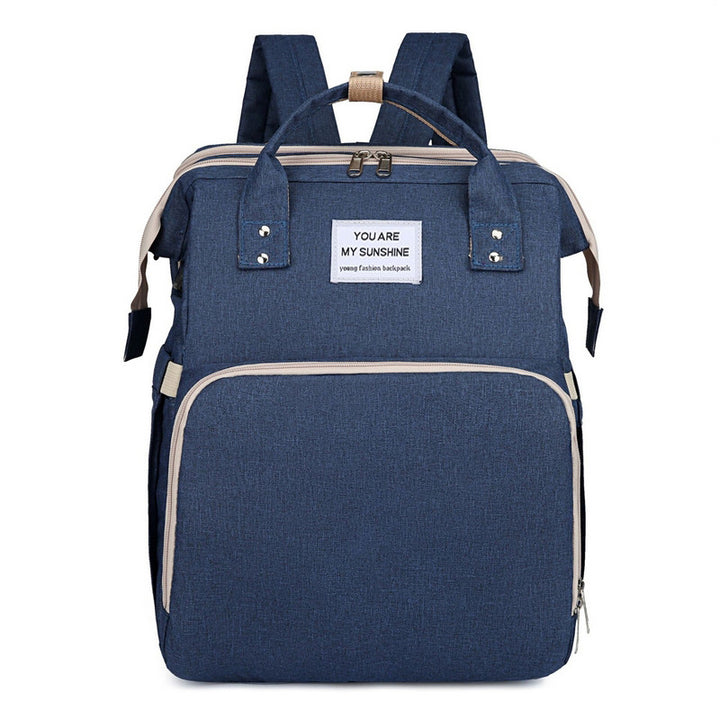 Diaper backpack with integrated changing bed