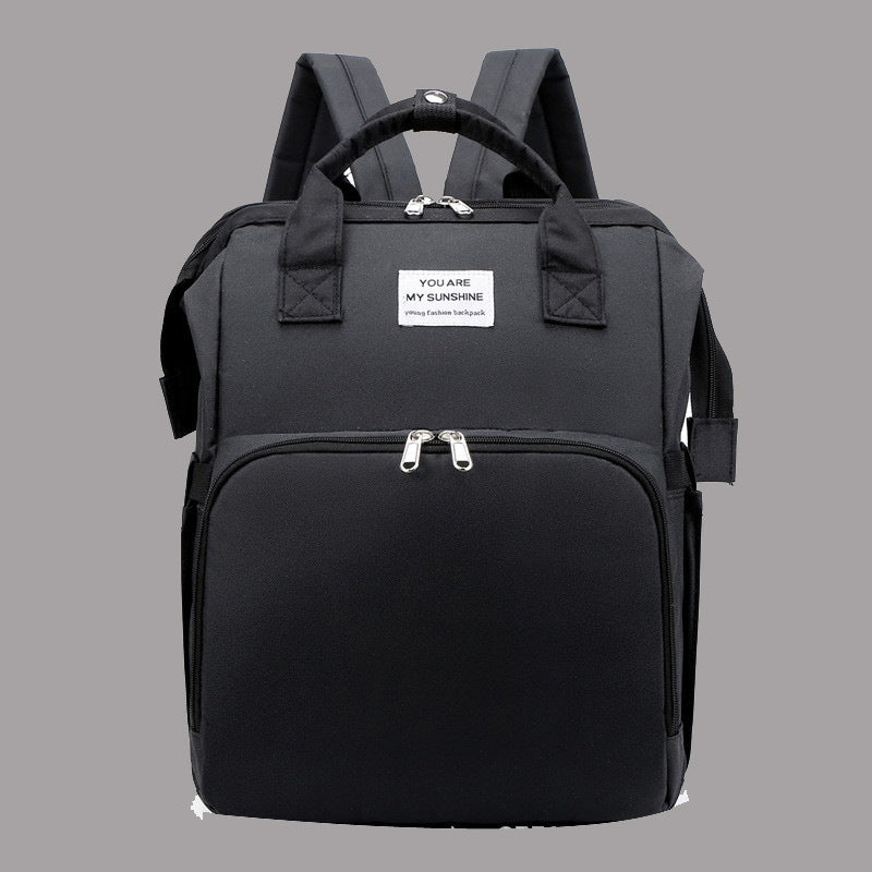 Diaper backpack with integrated changing bed
